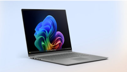 Laptop open with rainbow colored bloom on desktop