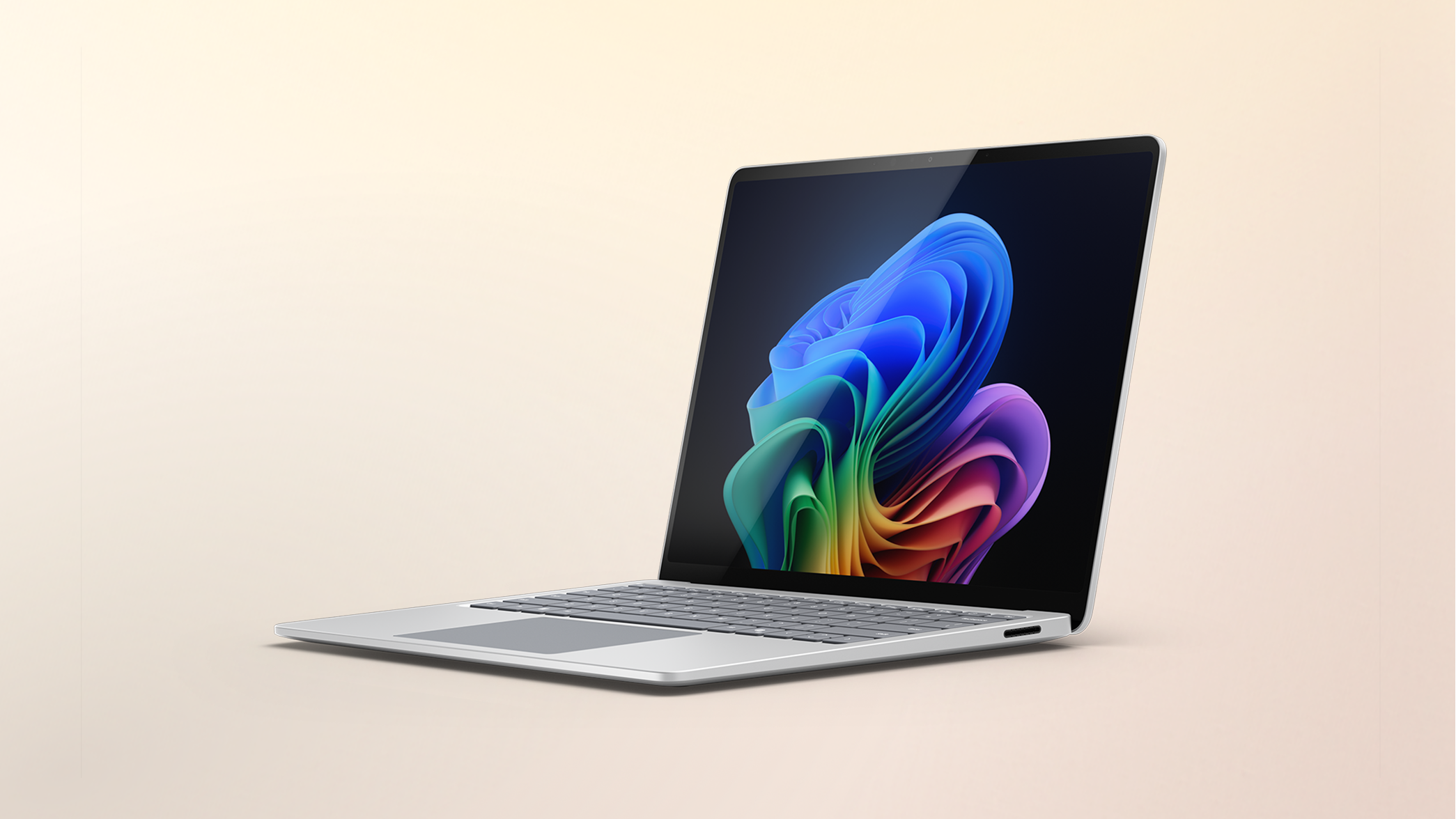 Surface Laptop Copilot+ PC Snapdragon on a peach gradient background