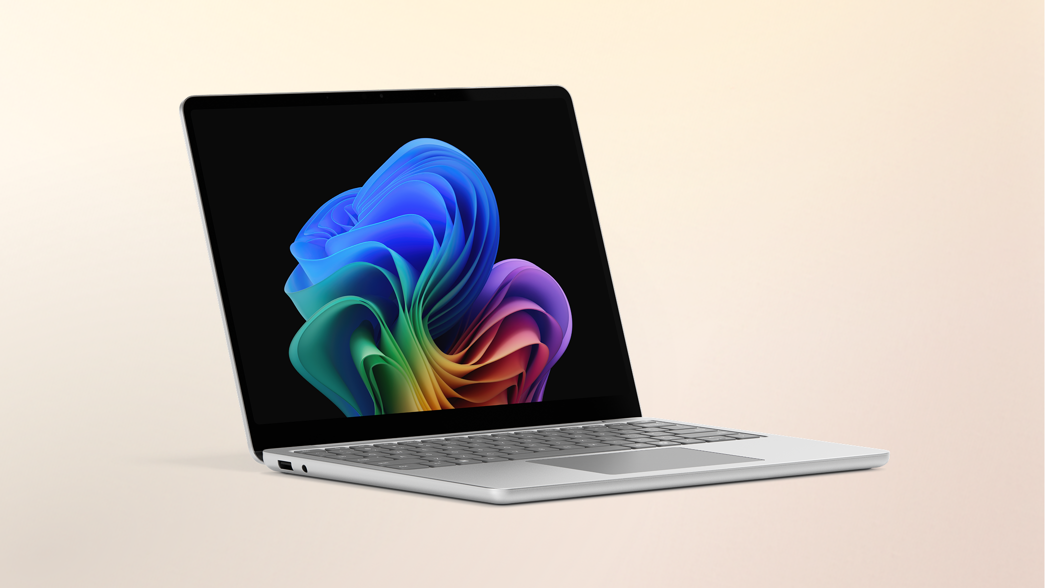 Surface Laptop Copilot+ PC 13-inch Snapdragon on a peach gradient background