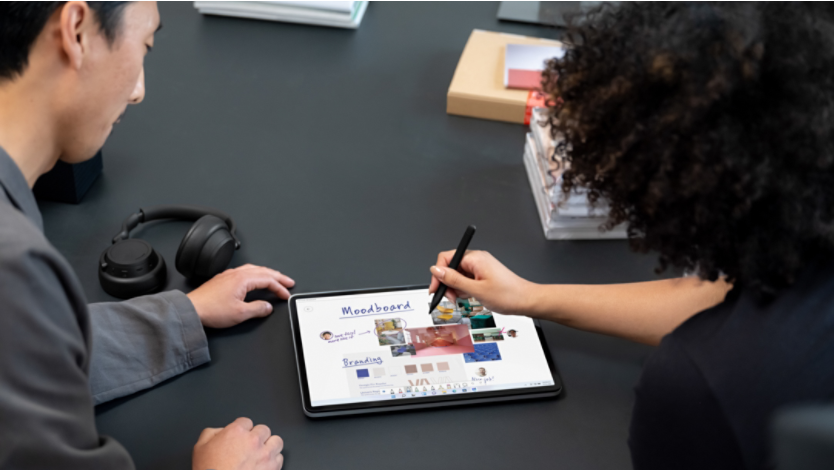 two people using a stylus on Surface Laptop Studio