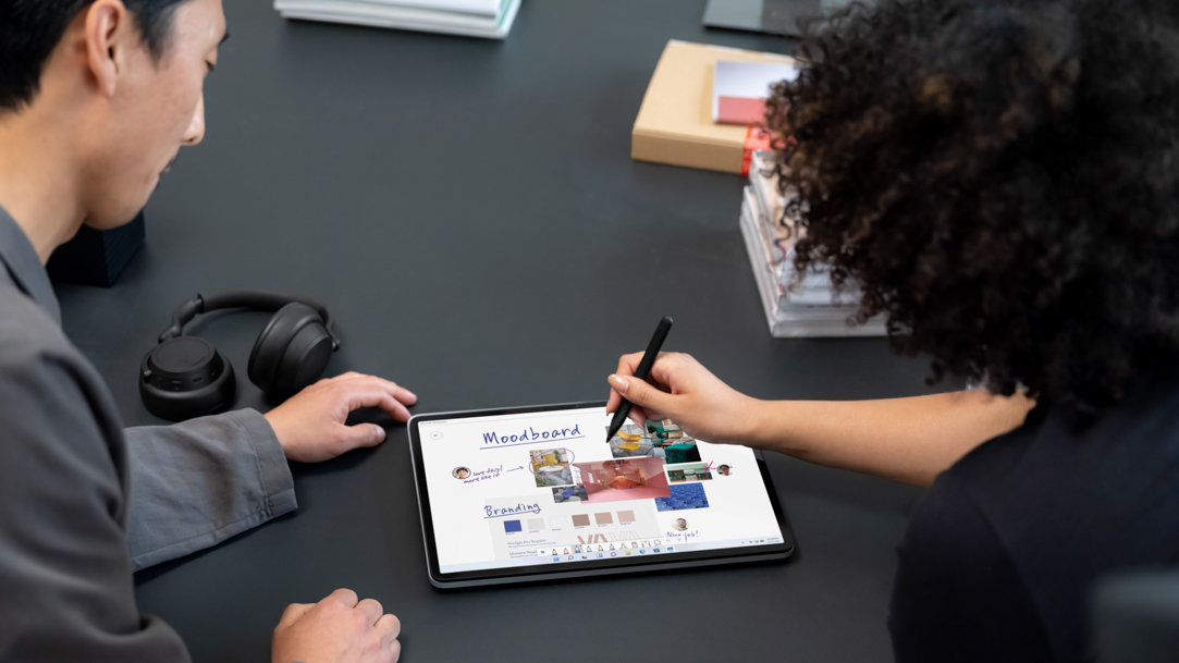 two people using a stylus on Surface Laptop Studio