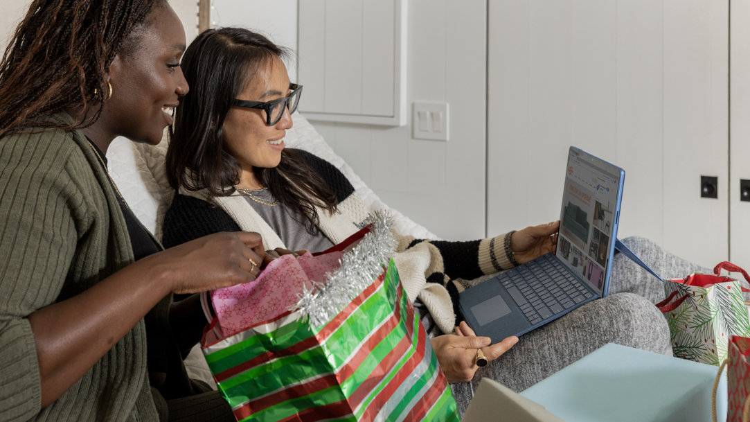 two women using a Surface device