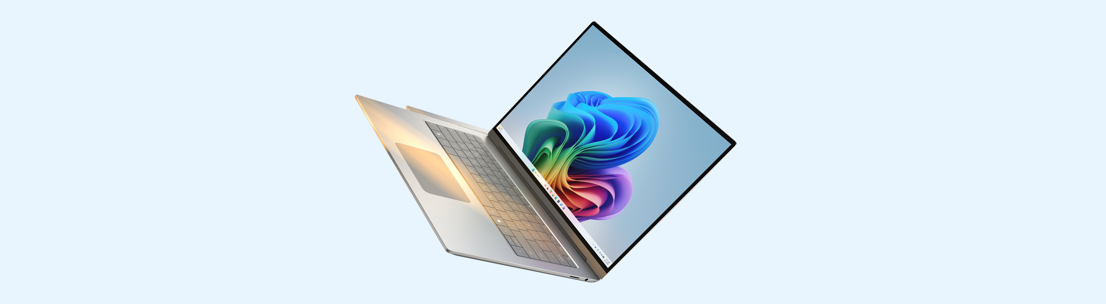 An open Windows 11 Pro PC with the bloom image on screen tipped dramatically against a pale blue background