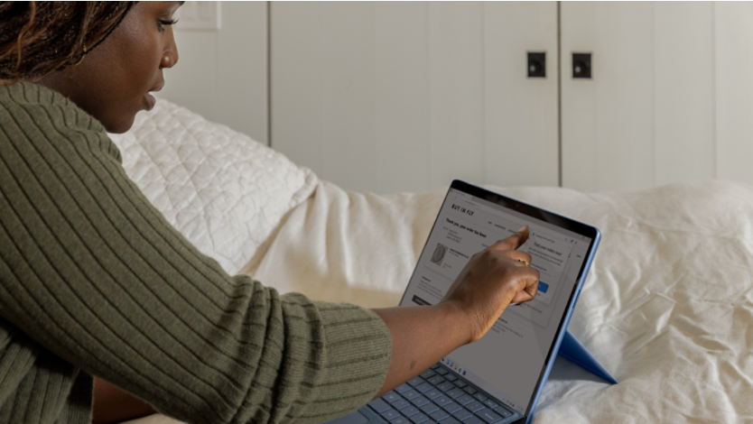 A woman using browser extensions on her Surface device