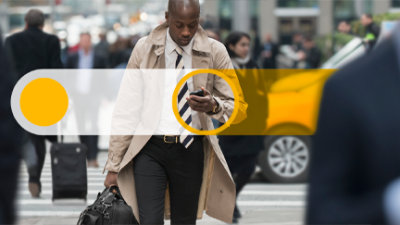A person walking down the street with a phone