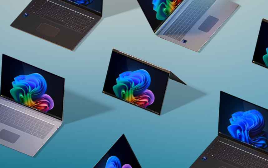 Multiple laptops and two-in-one devices displaying the Windows 11 start screen 