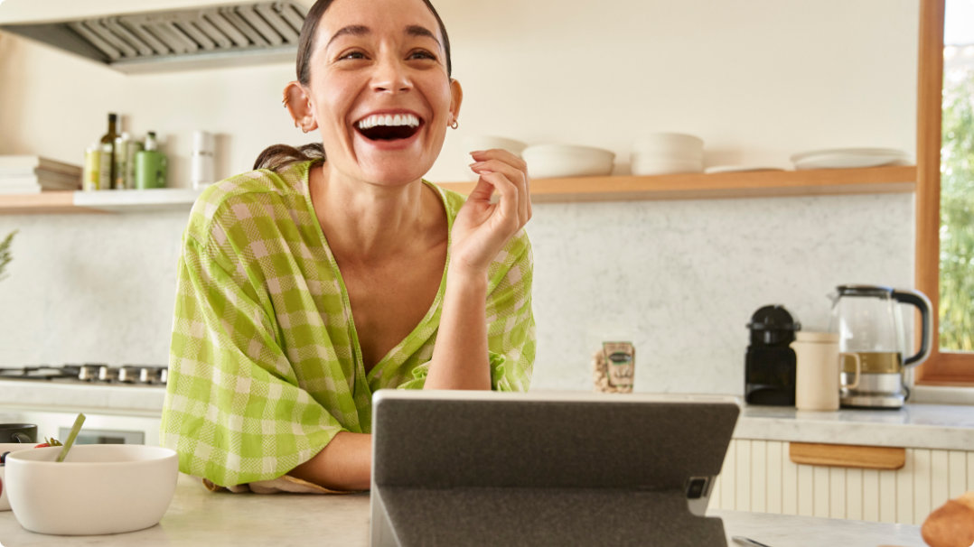 Woman smiling sitting in front of her laptop