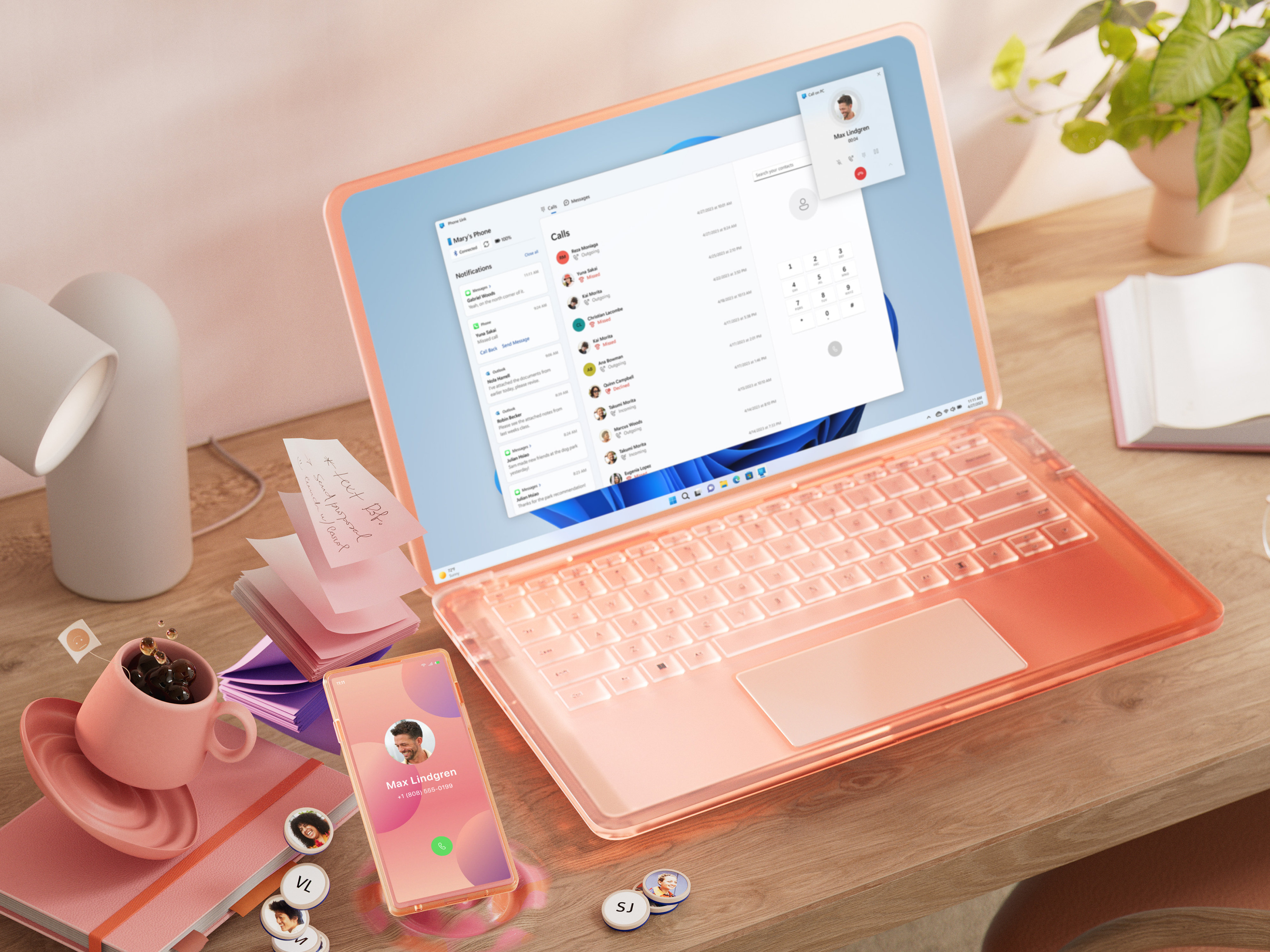 Un PC coloré et un appareil mobile sur un bureau, aux côtés d’une tasse de café et d’un stylo
