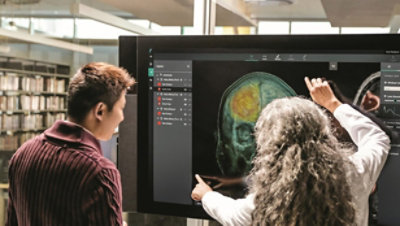 A group of people looking at a computer screen