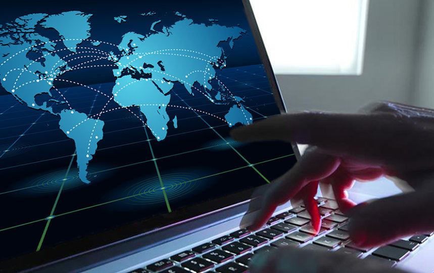 Hands typing on a laptop where the display shows map points and lines on a world map.