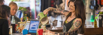 A girl is serving coffee to few peoples