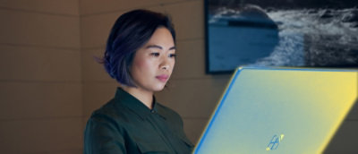 A woman looking at the computer screen