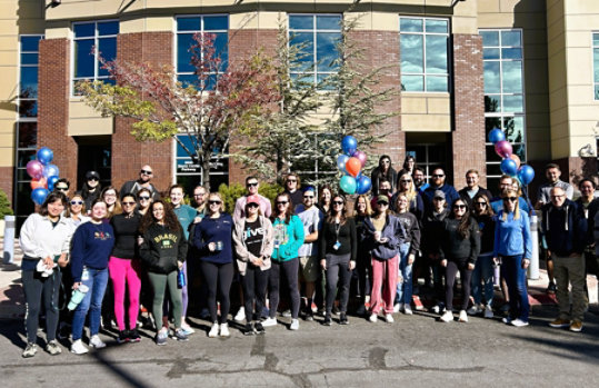 A group of Microsoft Reno employees standing in front of the Americas Operations Center in Reno, Nevada. 
