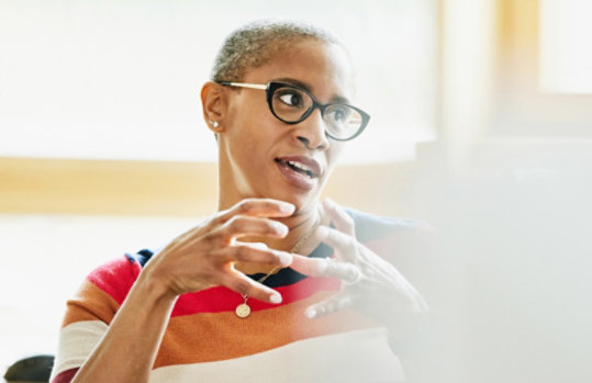 Woman discussing a topic at work.