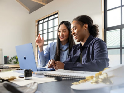 A man and a woman looking at a laptop.