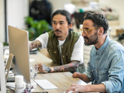 A group of men looking at a computer screen