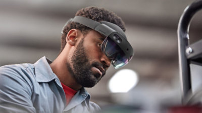 A man using a Microsoft HoloLens glass to work
