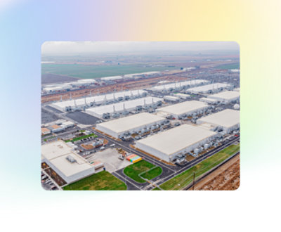Aerial view of a sprawling industrial plant with smokestacks and warehouses.