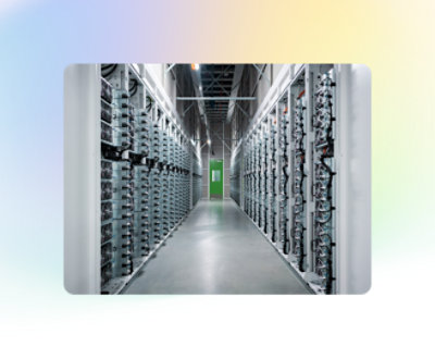 A long hallway in a data center, with rows of server racks on both sides and a green door at the end, enclosed by a frame with gradient colors.