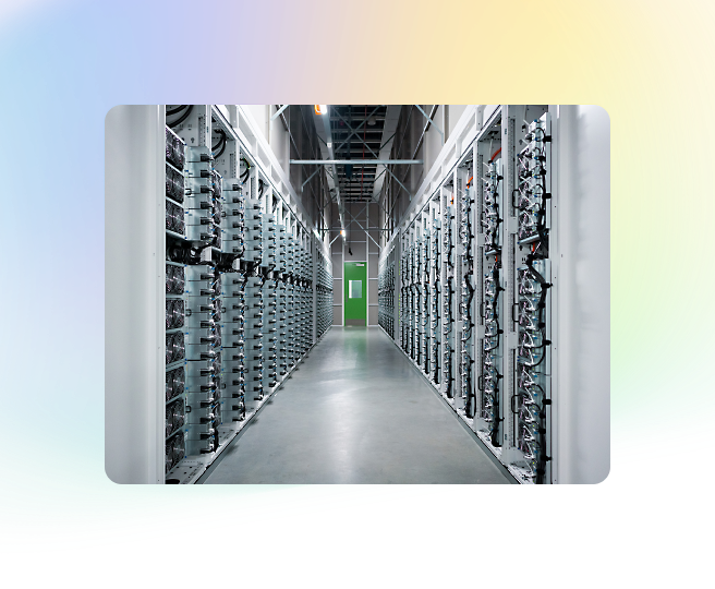 A long hallway in a data center, with rows of server racks on both sides and a green door at the end, enclosed by a frame with gradient colors.