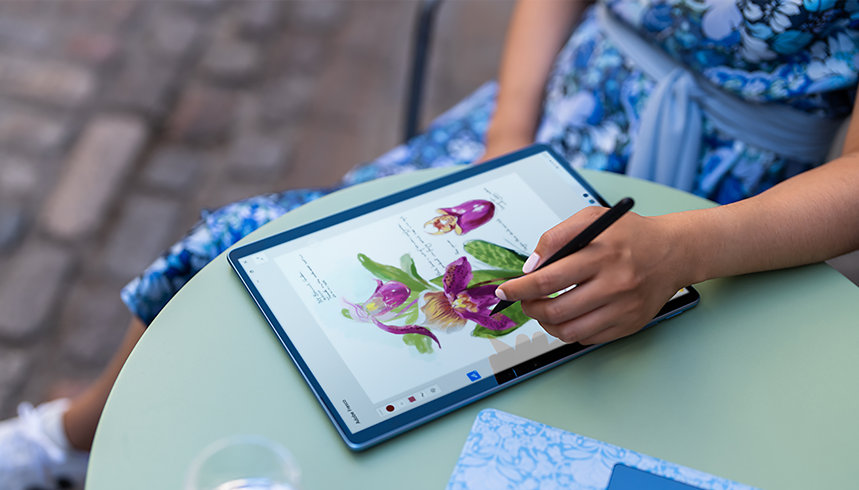 A person uses a Surface Slim Pen 2 on a Surface Pro 9.