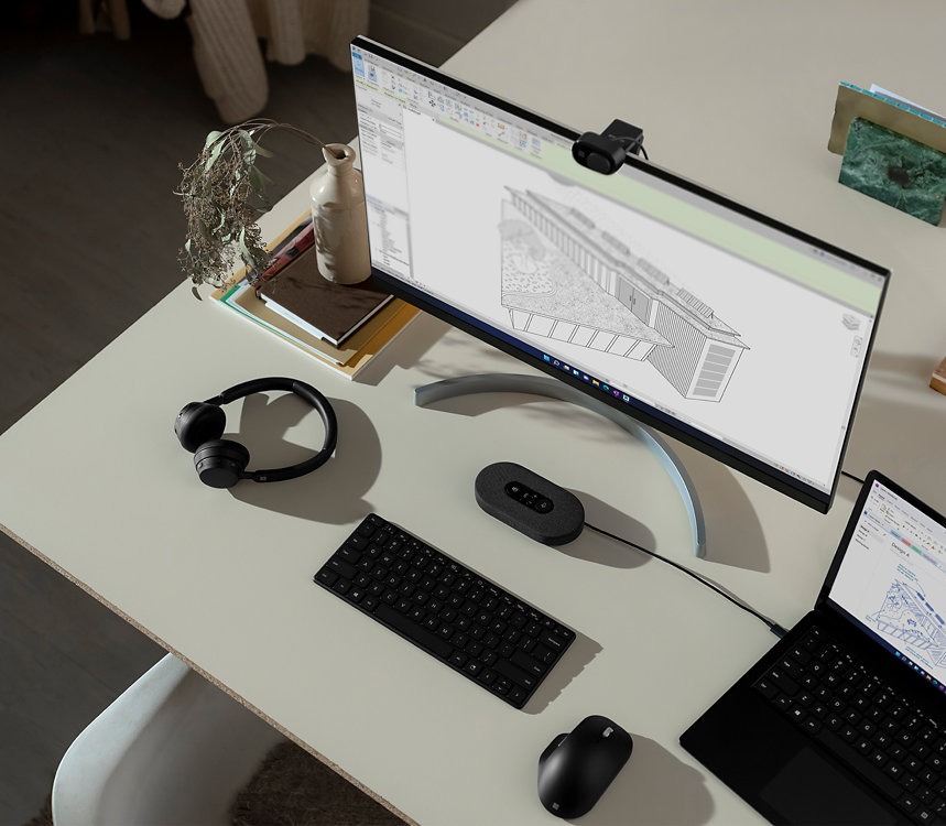 A top-down view of a desktop setup showing various Surface accessories.  