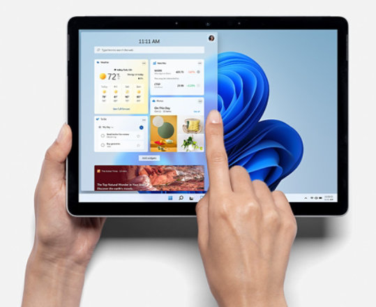 Person using Surface Go 3 as a tablet featuring Windows 11.