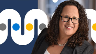 A person with curly hair wearing glasses