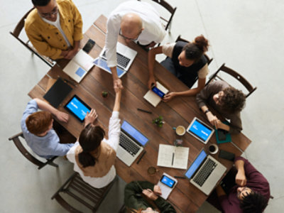 A group of people sitting on chairs and using their laptop, mobile and tablets