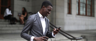 Person in blazer looking at mobile