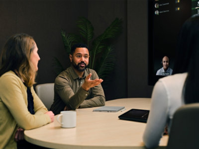 A group of people sitting in conference room and smiling