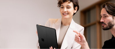 A man and woman looking at laptop and discussing