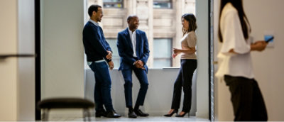 A group of people standing in a room.