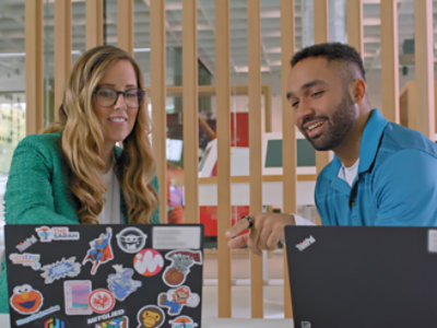 Two persons looking at a computer
