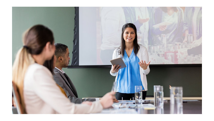 Person making a presentation to other people in a boardroom