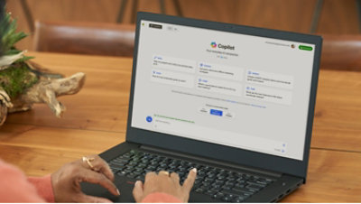 A person launching Microsoft Copilot on a laptop.