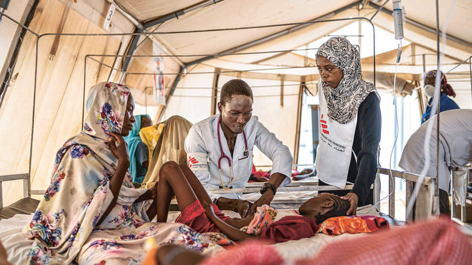 Medical professionals tending to a child in a clinic.
