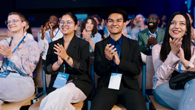 Audience applauding at a conference.