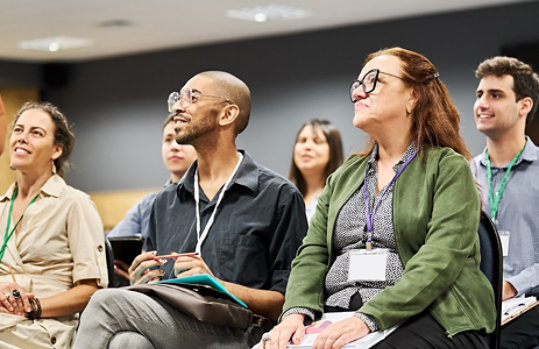 Attentive audience members enjoying a presentation.