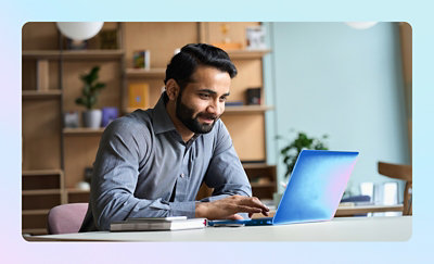 Person working on a laptop at a desk