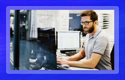 A man sitting at a desk using a computer.