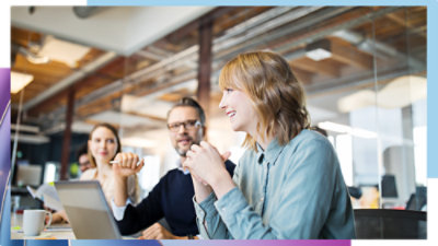 Team members collaborating in an office meeting.