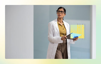 A woman in a white coat holding a clipboard.