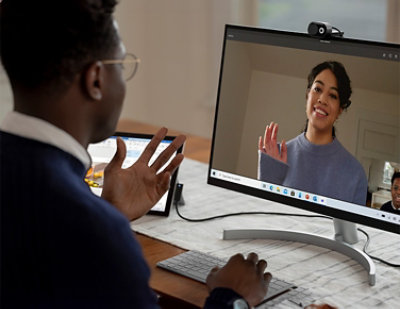 A man and a woman are having a conversation on a computer.