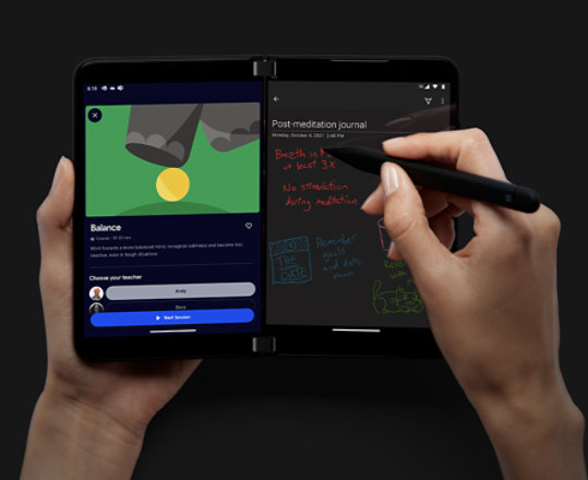 A person writing with Surface Slim Pen 2 using Headspace and OneNote apps on Surface Duo 2.