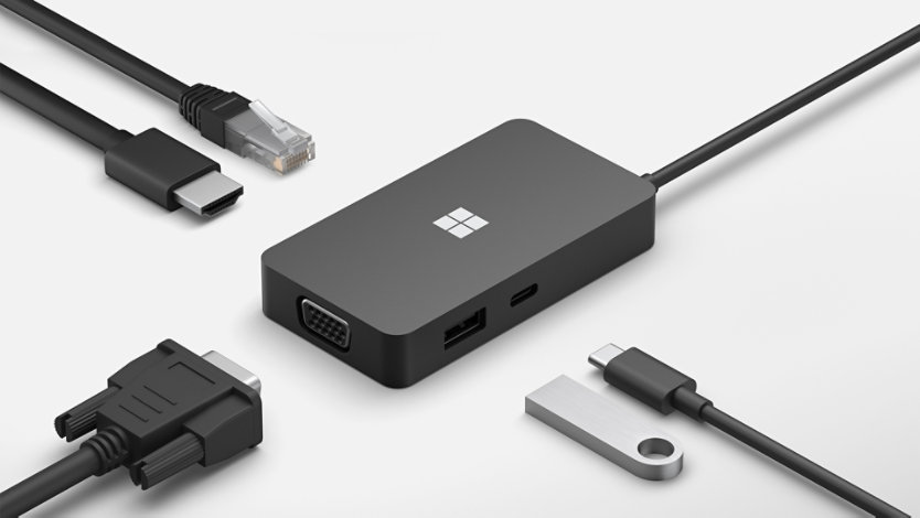 A Surface USB-C Travel Hub for Business surrounded by various connective cables. 
