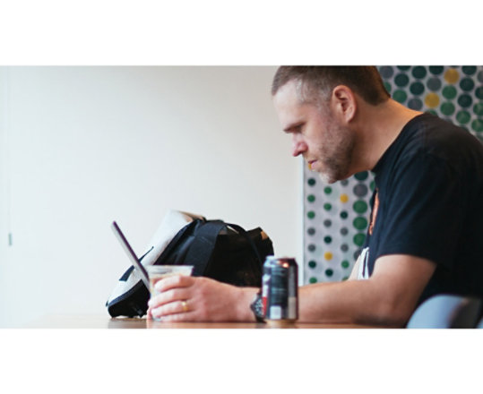A man sitting at a desk working on his Windows 10 computer.