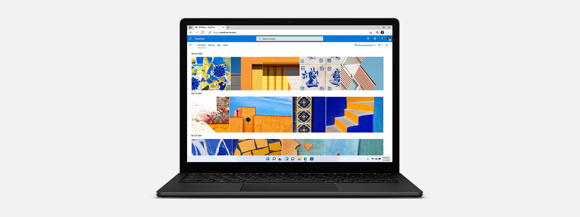 A Surface Laptop 4 displays multiple photos in OneDrive.