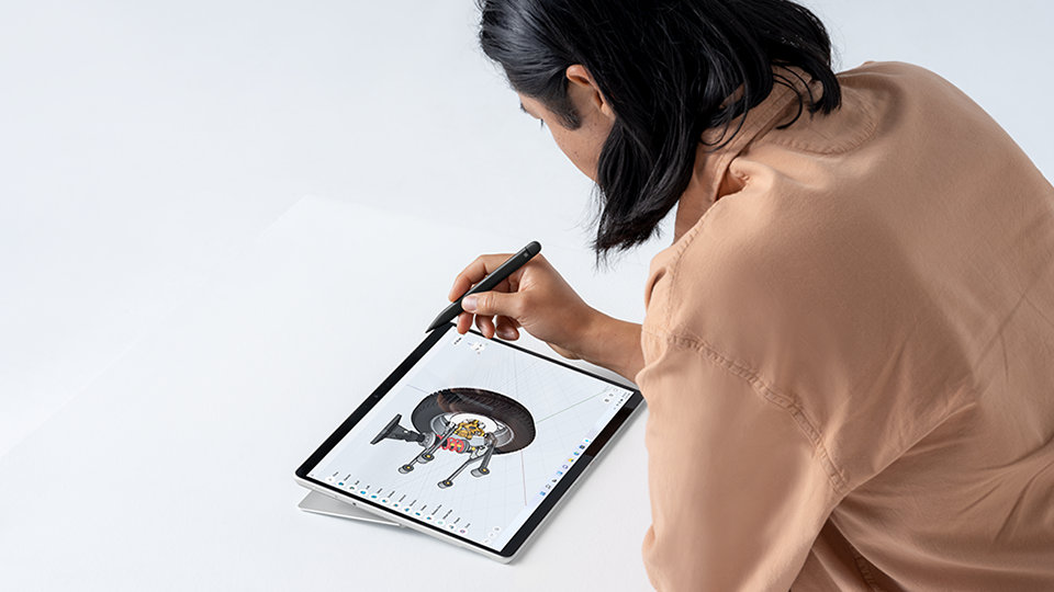 A person using a Slim Pen 2 to add expert shading to a design.