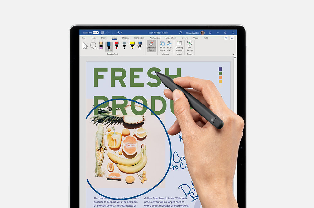 A person’s hand designing with a Surface Slim Pen 2 for Business on a tablet.